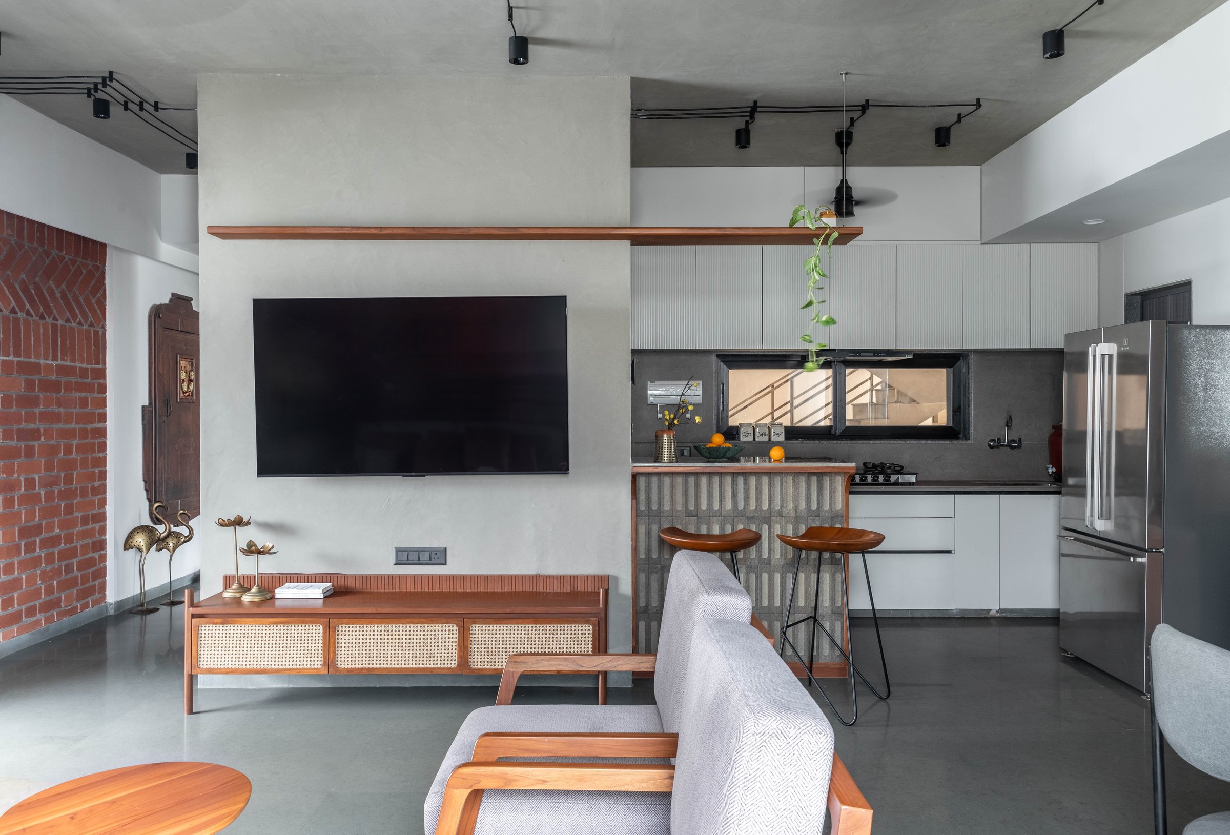 The open kitchen's concrete-block breakfast counter, holding its own against white cabinetry beyond