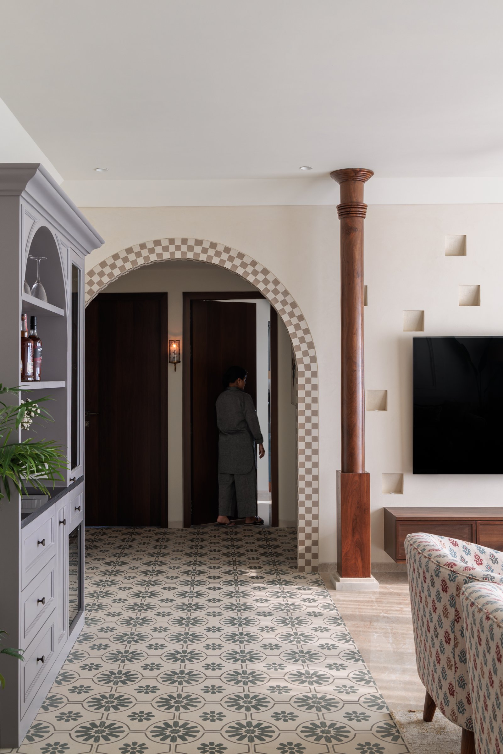 Checkered arch, timber column, and patterned tile: the spatial logic of the home's threshold between public and private zones