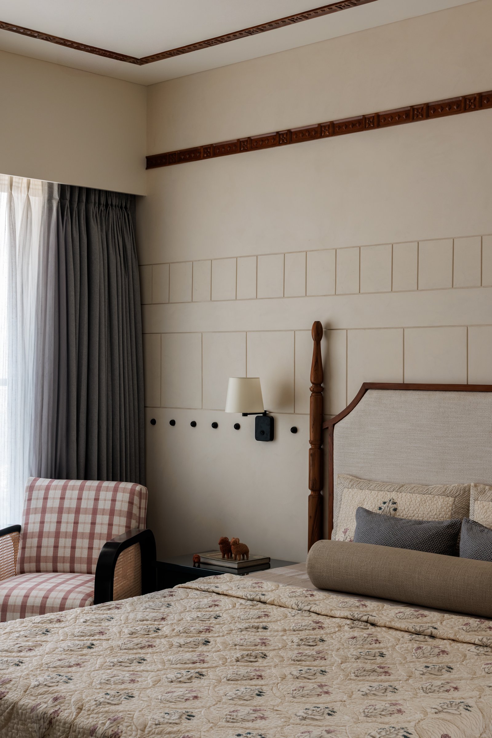 The master bedroom: turned timber finials, raised wall mouldings, and a carved ceiling trim sustain the home's classical references